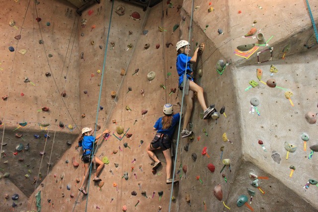 Blue campers working the climbing wall